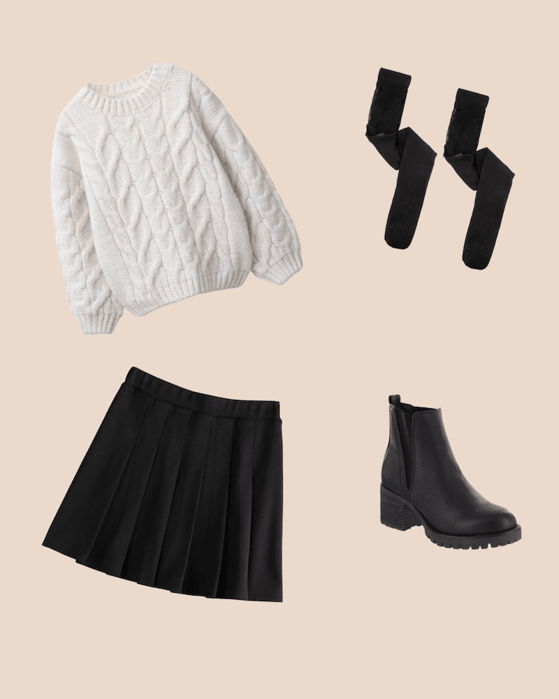 Flat lay of a cream cable-knit sweater, black knee-high socks, a black pleated skirt, and low-heeled ankle boots on a beige background—perfect for classic looks and cozy fall fashion.