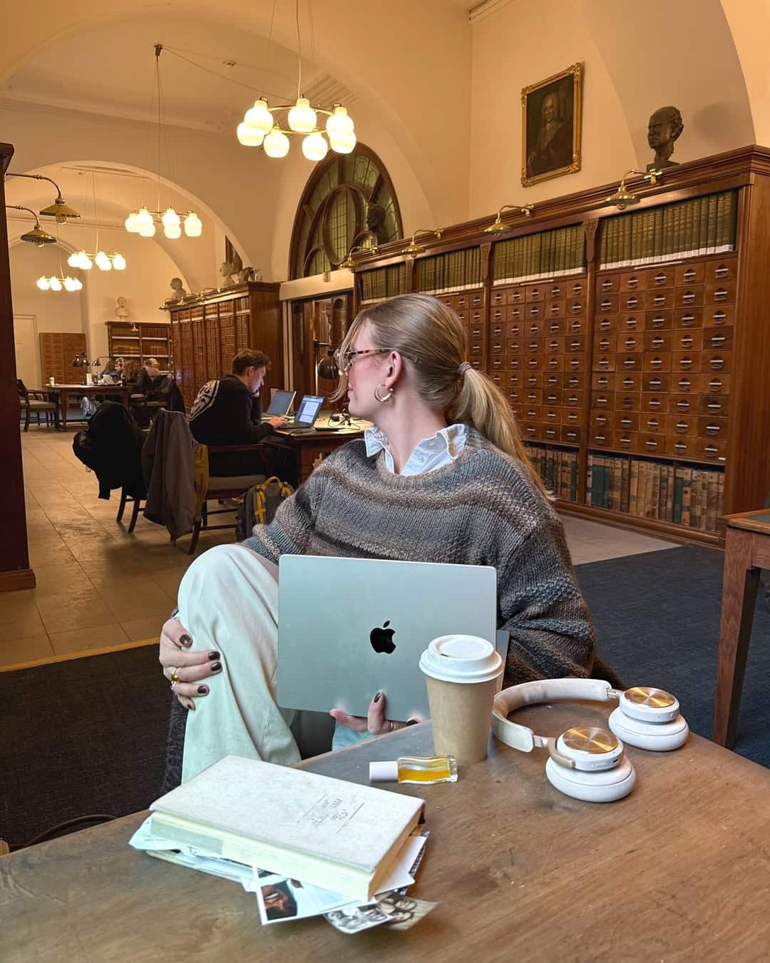 student in library looking at emails