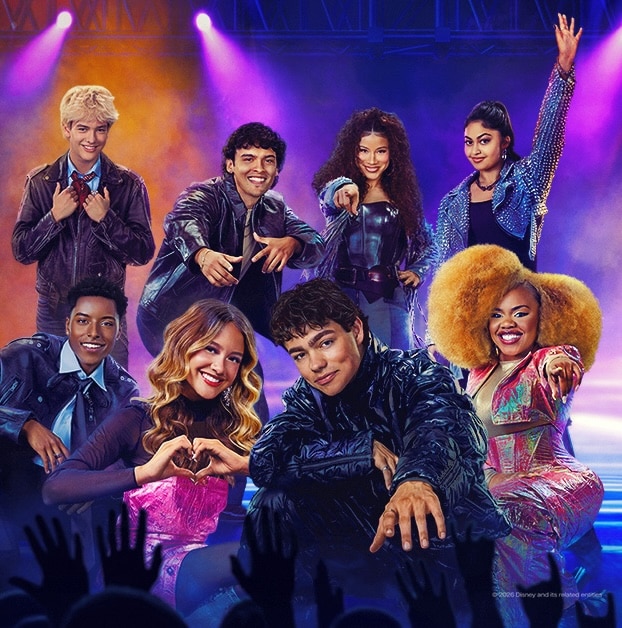 A group of eight smiling young performers in colorful, trendy outfits pose confidently onstage under vibrant lighting, where worlds collide and audience hands cheer wildly at the bottom of the image.